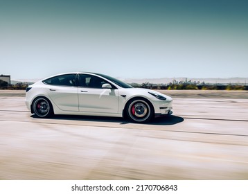 LA, CA, USA
March 21, 2022
White Tesla Model Y Driving On The Road Showing The Passenger Car