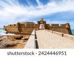 La Caleta Beach, Balneario de la Palma Building and Castle of San Sebastian at sunset - Cadiz, Andalusia, Spain