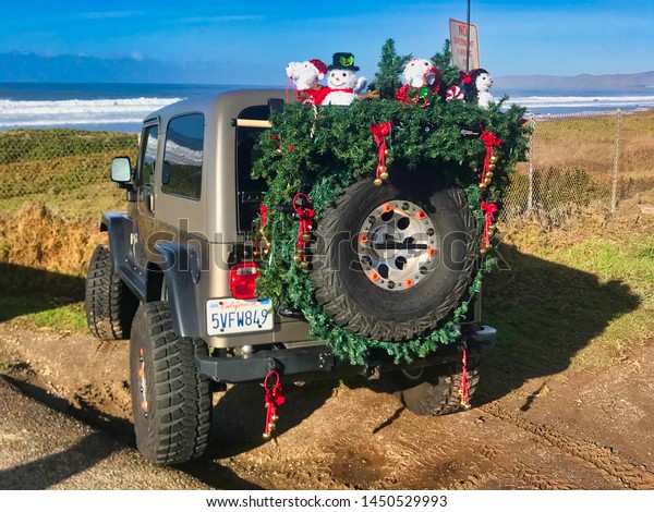 L.A. california,\
february 04 2019: american car with big tires and snow men and\
trees for new year\
holidays