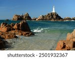 La Corbiere lighthouse, Jersey, U.K. Summer coastal image of a landmark and teal seas.