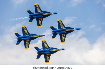 La Crosse, WI, USA - June 13, 2021: Blue Angles From US Navy Team Show Formation Alignment Fly Speed Skills With Engine Smoke Over Clouds Sky In Airfest 2021. Aviation Festival, Airshow In America.