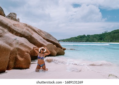 La Digue Tropical Island Seychelles, Young Woman At The Beach During Vacation, Mid Age Asian Woman At The White Beach Of The Seychelles Looking Over The Ocean