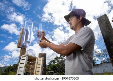 La Esperanza, Intibucá, Honduras. December 20 2020. A Young Man Revising The Amount Of Rainfall With A Pluviometer