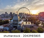 La Grande roue de Montreal Ferris wheel and downtown skyline in summer dusk. Quebec, Canada.