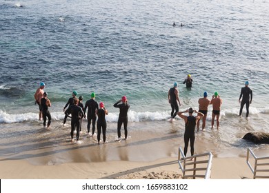 LA JOLLA, CALIFORNIA/USA - MARCH 27, 2016:  A group of people prepare to enter the ocean at La Jolla Cove for open water swimming.