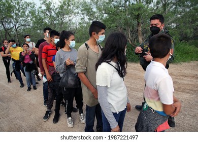 La Joya, TX, USA - May 26, 2021:  A Border Patrol Agent Talks With A Group Of Unaccompanied Central American Minors Who Crossed The Rio Grande River Illegally To Request Asylum.