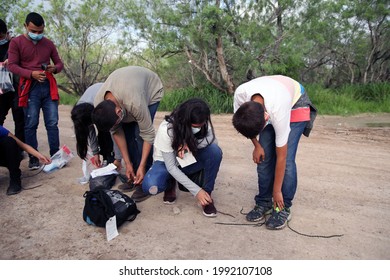 La Joya, TX, USA - May 26, 2021:  A Group Of Unaccompanied Central American  Minors Who Crossed The Rio Grande River Illegally To Request Asylum Remove Their Shoelaces Per Border Patrol Procedure.