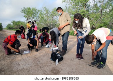 La Joya, TX, USA - May 26, 2021:  A Group Of Unaccompanied Central American  Minors Who Crossed The Rio Grande River Illegally To Request Asylum Remove Their Shoelaces Per Border Patrol Procedure.