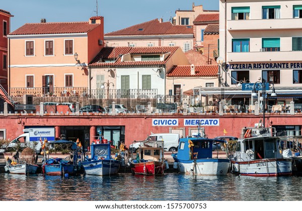 LA MADDALENA, ITALY – SEPTEMBER 13, 2019:\
Fishing boats moored in the port in La Maddalena,  the largest town\
in the Maddalena archipelago in the Straits of Bonifacio, between\
Italy and Corsica.