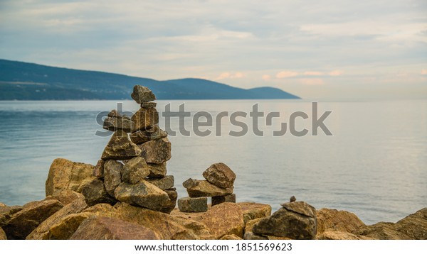 La Malbaie, Canada - August 17 2020: Stunning\
landscape view with the prayer stones by the saint lawrence river\
in La Malbaie in Quebec