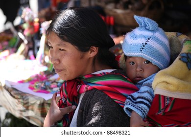 LA PAZ, BOLIVIA-JAN. 5: An Unidentified Indian Woman Carries Baby In Traditional Sling January 5,2009 In La Paz, Bolivia. Bolivian Women Use Slings For Centuries But Now Strollers Compete With Slings.