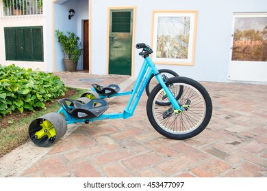 La Romana, Dominican Republic - February 16, 2016: Cool Sport Bicycle Or Tricycle Blue Color With Iron And Plastic Hull And Big Rubber Tyre For Sand Has Three Wheels Standing On Stony Road 