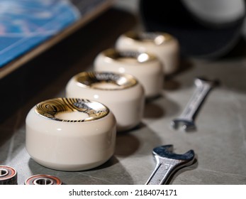 LA, UNITED STATES, APRIL 2022: CLOSE UP: Overview of lined up skateboard wheels and wrenches on gray countertop. New skateboard elements and other parts arranged on work desk ready for assembling. - Powered by Shutterstock