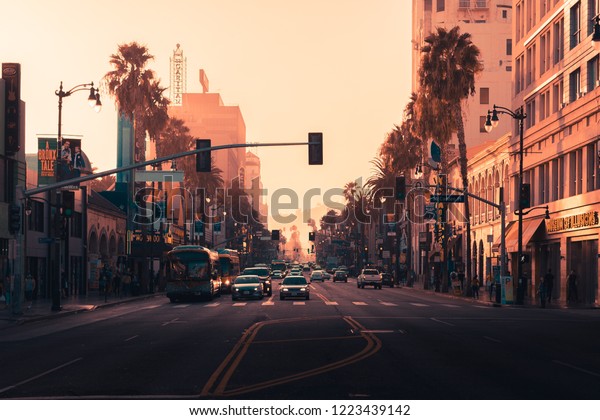 LA, USA - 30th October 2018: Beautiful orange and\
pink sunset on Hollywood Blvd, LA, California - Looking directly at\
stationary traffic