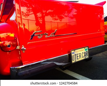 La Verne, California / USA - March 18, 2017: Tree Reflection On The Tailgate Of A Red And Orange Custom 1955 Ford F100 Pickup Truck On Display At A Car Show In The Parking Lot Of Bonita High School