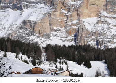 La Villa, Italy February 2021: Alpine wooden huts at the foot of the Sasso della Croce mountain range. Alta Badia in the Dolomites. South Tyrol, Italy.