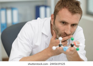 lab assistant checking a dna model