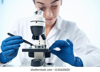  lab assistant conducts microscope experiments examining molecules                              