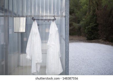 Lab Coats Hanging In Plastic Change Room