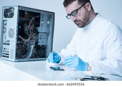 Lab Engineer Repairing And Fixing Broken Hard Disk For Data Recovery