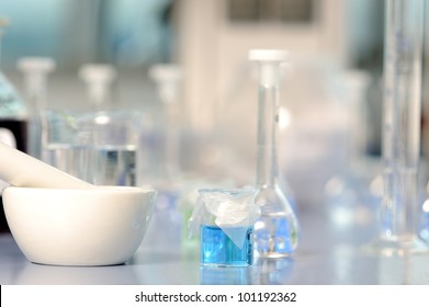 Lab flasks and grinding pestle - Powered by Shutterstock