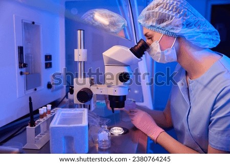 Lab scientist focused on selecting oocyte samples for vitrification