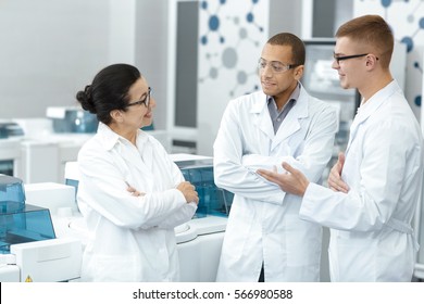 Lab Team. Multiethnic Group Of Laboratory Scientists Discussing Their Research At The Lab Teamwork Technician Specialist Profession Job Colleagues Medicine Chemists Biologists Team Study Communication