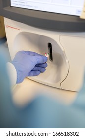 Lab Tech Doing A Blood Gas Analysis On Sample