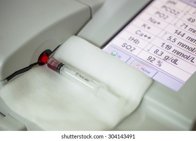 Lab Tech Doing A Blood Gas Analysis On Sample