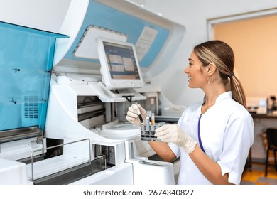 Lab tech loading samples into a chemistry analyzer. female lab tech loading specimen for coagulation test analysis