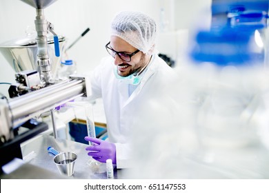 Lab Technician Doing Water Analysis, Dressed In Protective Sterile Equipment. Drinking Water Production.