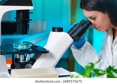 Lab Technician Examining plant tissue with microscope - Powered by Shutterstock