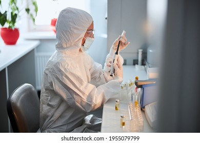 Lab Technician In A Hazmat Suit Getting Ready For Work