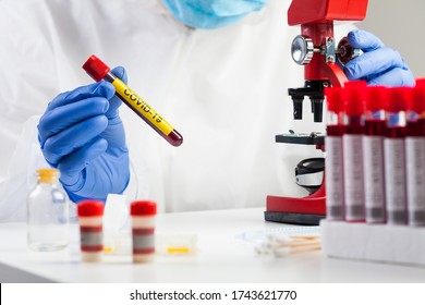 Lab Technician Holding Test Tube With Label COVID-19,microscope Analysis Of Recovered Coronavirus Patient Blood Specimen Sample,antibody Convalescent Platelet Rich Plasma Serum Therapy,immune System 