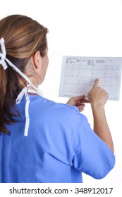 Lab Technician In Scrubs And Mask Holding EKG Results Shot From The Back On A White Background Portrait Close-up