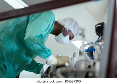 Lab Technician At Work As Researcher In Biotech Industry With Precision Equipment