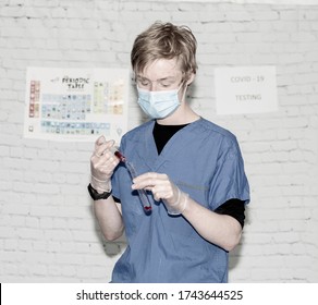 Lab technician working with a syringe and test tube wearing gloves and a face mask.