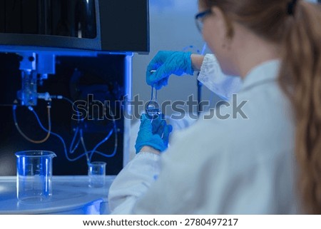 Lab work, scientists holds a test tube takes the test from a test tube in analysis for vaccine development.