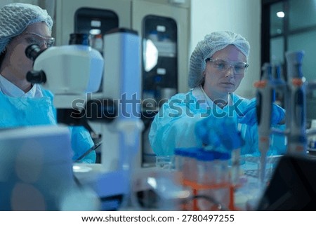 Lab work, scientists holds a test tube takes the test from a test tube in analysis for vaccine development.