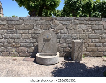 Bénévent L'Abbaye La Creuse France. June 11 2022. Stone Water Feature Set Against A Stone Wall And Shadow Here At Bénévent L'Abbaye A Town In Rural Central France. 