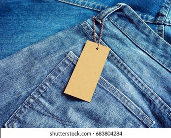 Label Blank Price Tag Mockup On Blue Jeans.