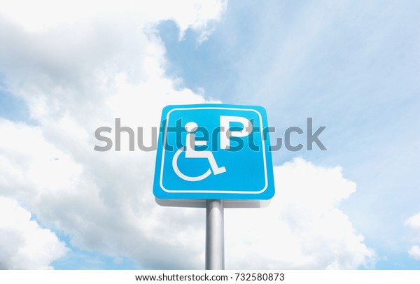 Label disabled parking on Cloud and blue sky background.\
Label symbol Disabled parking on the road for Disabled parking\
only. Thailand. 