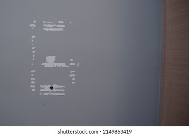 Label marks and drilling hole on a wall - wear and tear