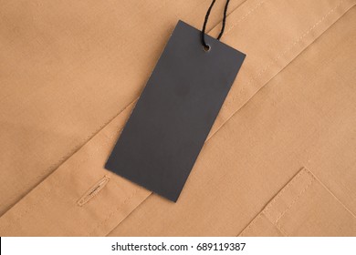 Label Price Tag Mockup On Beige Shirt.