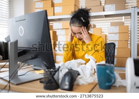 Label printer malfunction on work desk while stressed warehouse owner faces business problems and operational failure in storage office