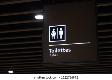 Label Of Symbol Of Toilet For Men And Women On Blue Plate, Direction  Sign And Navigation Pointer WC Restroom In The Building, Airport, Station