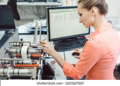 Labels to be printed on being inserted into printing machine by woman
