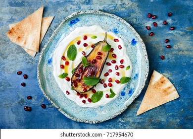 Labneh Middle Eastern Lebanese Cream Cheese Dip With Roasted Aubergine, Pomegranate, Mint And Pita. Top View, Overhead