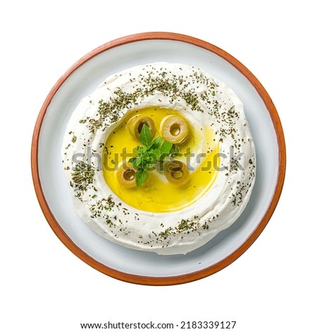 Labni with olives, arabic paste with olives top view on plate, isolated on white background
