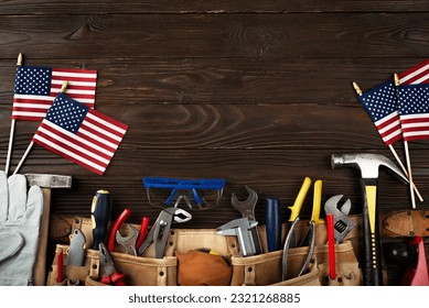 Labor day banner mockup of tools toolbelt and us flag on wooden background - Shutterstock ID 2321268885